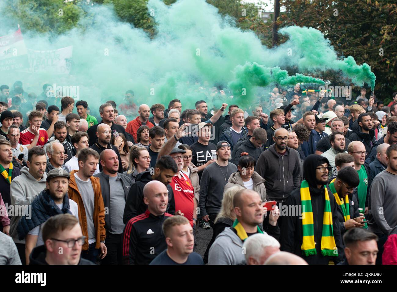 Protest march at Manchester United against Glazer owners. Large crowd. `Green smoke. Football match against Liverpool United. Stock Photo